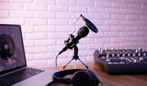 A simple podcast setup with a microphone, laptop and mixer